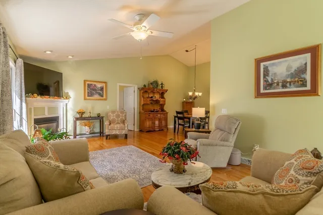 a living room with fireplace furniture and a flat screen tv