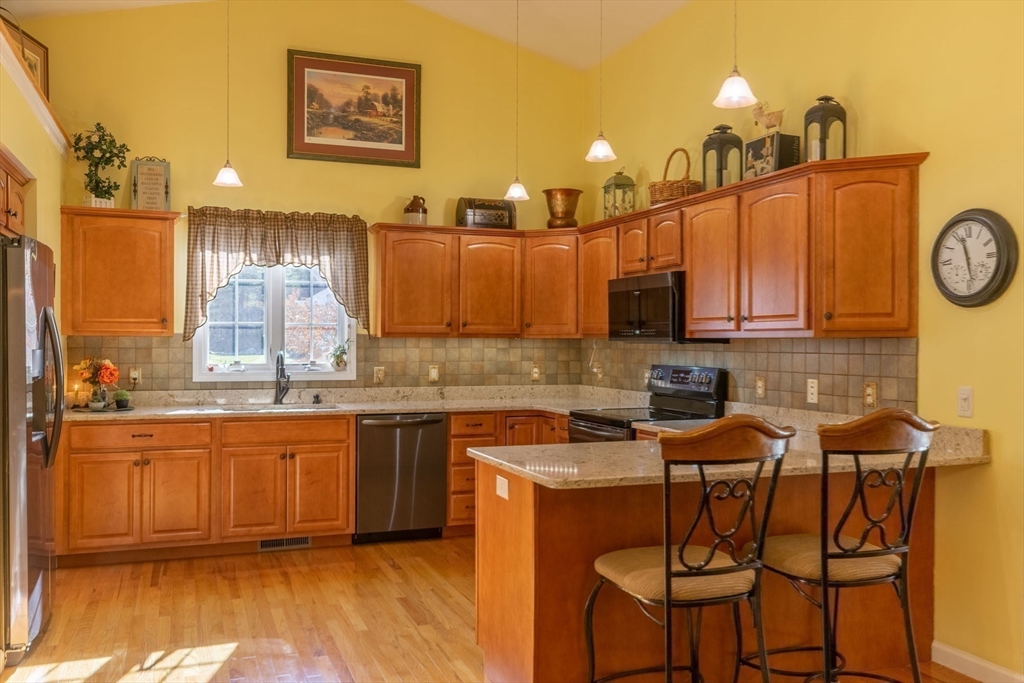 15 Michael Drive, Unit 15 Thorndike, MA 01079 - Photo 10 of 27 a kitchen with stainless steel appliances granite countertop a sink and cabinets