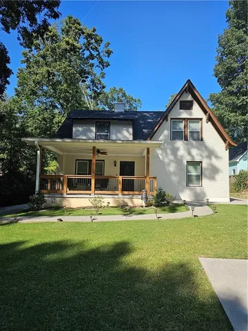 a front view of a house with a yard table and chairs