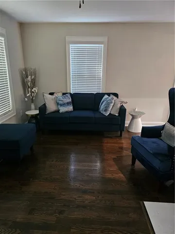 a living room with furniture and a potted plant