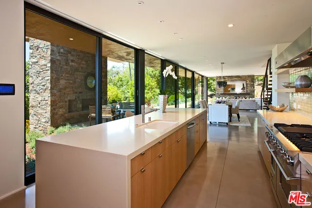 a large white kitchen with a large window