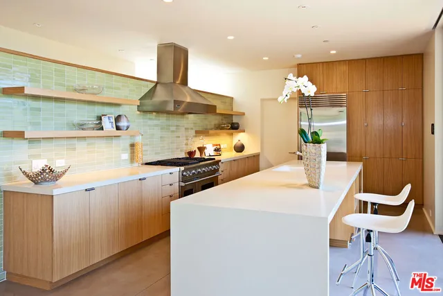 a kitchen with stainless steel appliances kitchen island granite countertop a sink and cabinets