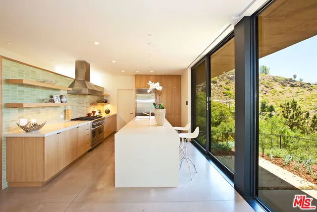 a large white kitchen with a large window
