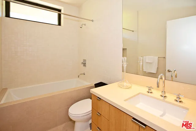 a bathroom with a sink a toilet and a bathtub