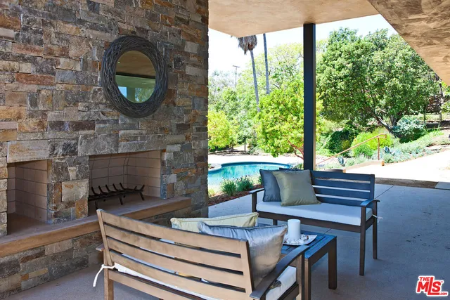 a living room with a fireplace and a floor to ceiling window