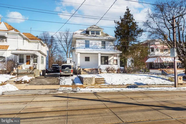 a view of a house with snow on the road
