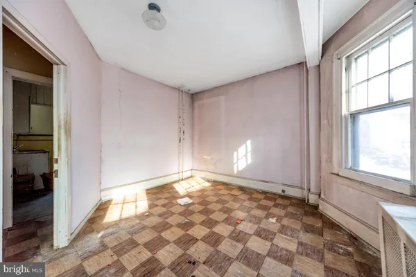 a spacious bedroom with a bed and a window