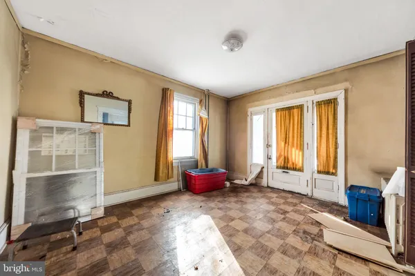 a view of a bedroom with a bed and wooden floor