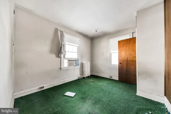 a kitchen with a refrigerator and white cabinets
