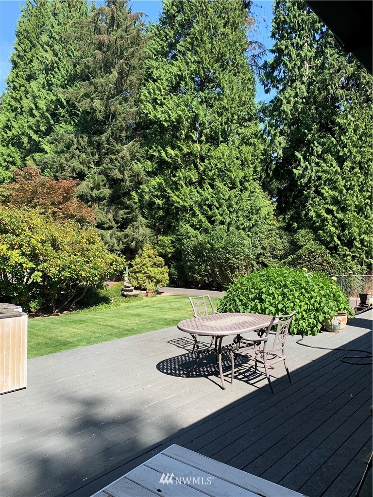 5615 227th Street Southeast Bothell, WA 98021 - Photo 11 of 30 a view of a patio with lawn chairs plants and wooden fence
