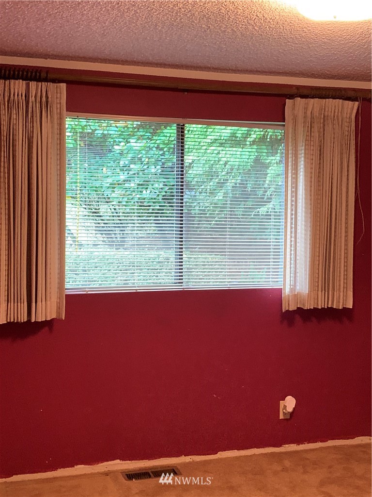 5615 227th Street Southeast Bothell, WA 98021 - Photo 19 of 30 a view of a room with a window and a bed