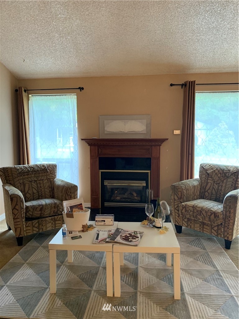 5615 227th Street Southeast Bothell, WA 98021 - Photo 20 of 30 a living room with furniture and a fireplace