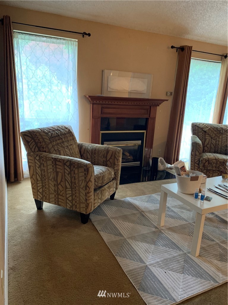 5615 227th Street Southeast Bothell, WA 98021 - Photo 21 of 30 a living room with furniture and a fireplace