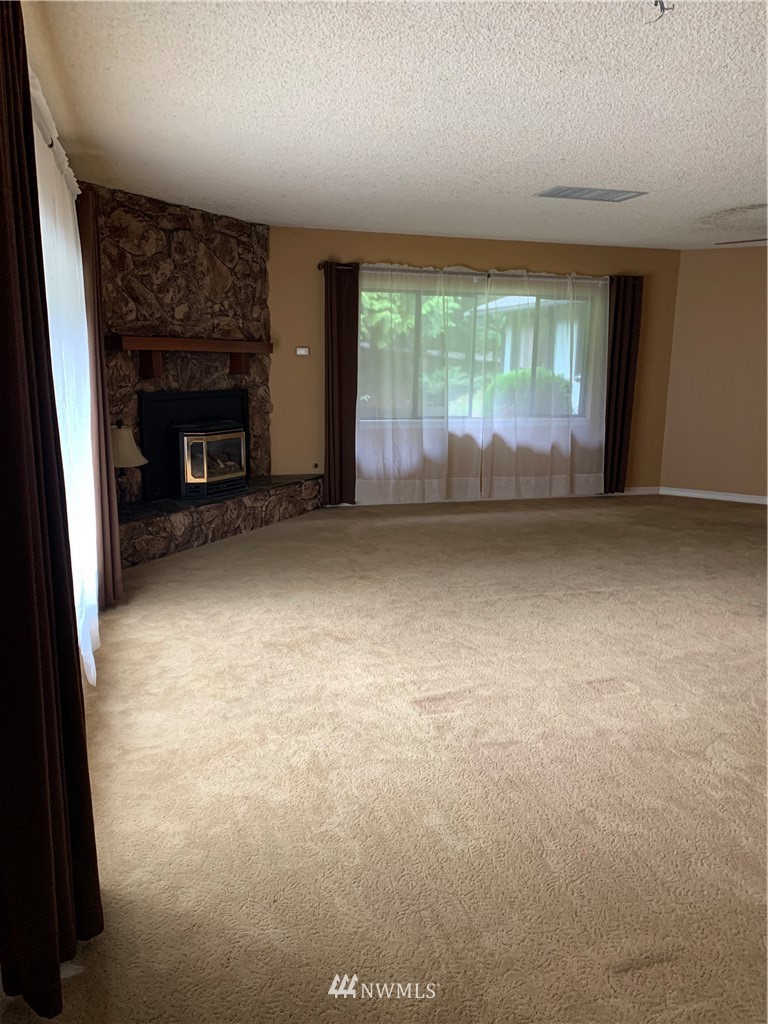 5615 227th Street Southeast Bothell, WA 98021 - Photo 22 of 30 a view of an empty room with a fireplace
