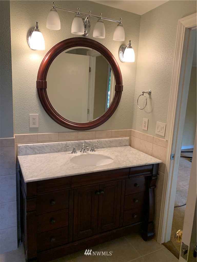 5615 227th Street Southeast Bothell, WA 98021 - Photo 26 of 30 a bathroom with a sink and a mirror