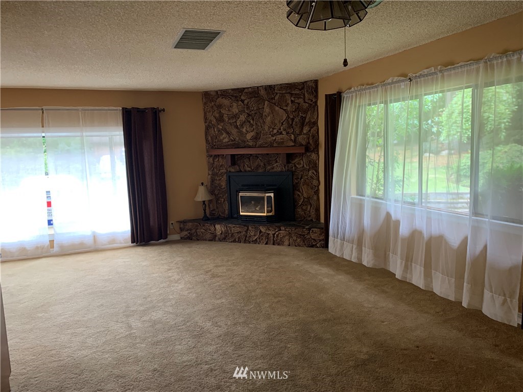 5615 227th Street Southeast Bothell, WA 98021 - Photo 30 of 30 a view of empty room with fireplace and windows