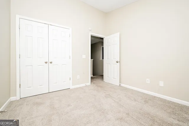 an empty room with closet area