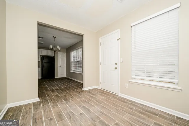 a view of a room with wooden floor and cabinet
