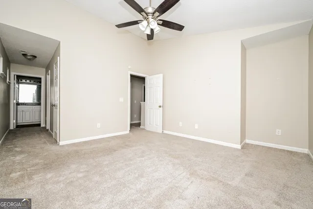 a view of an empty room with a ceiling fan