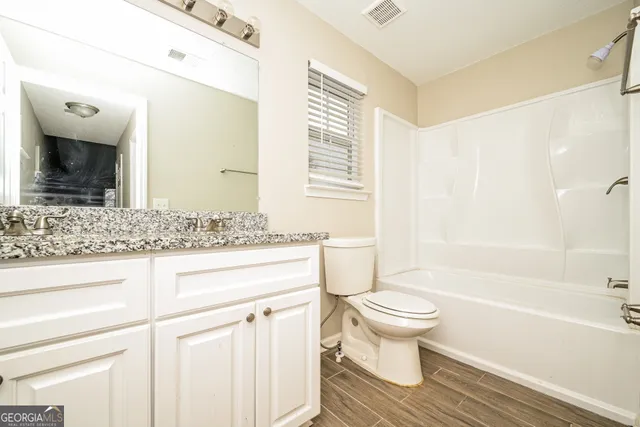 a bathroom with a sink a toilet and a bathtub