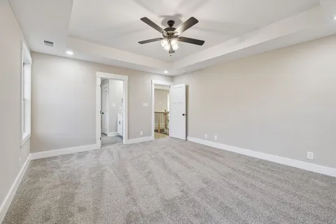 wooden floor in an empty room with a ceiling fan