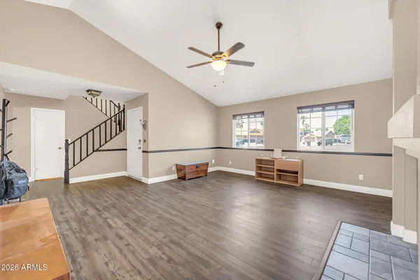 a living room with furniture and a large window with wooden floor