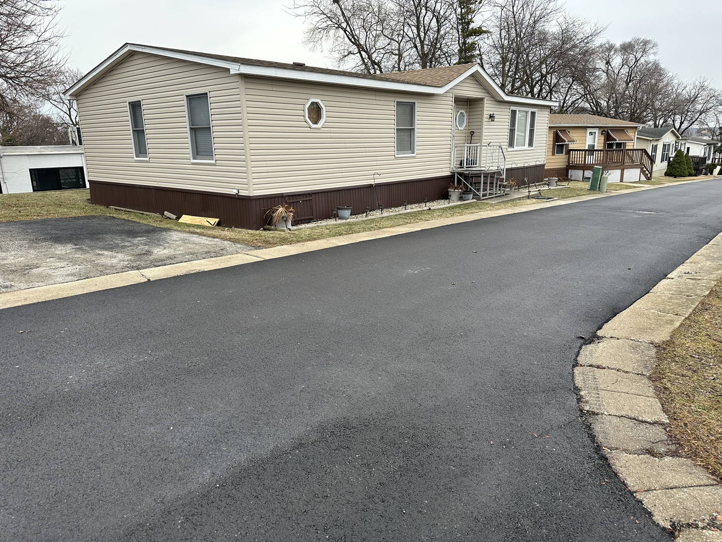6801 South La Grange Road, Unit 155 Hodgkins, IL 60525 - Photo 1 of 8 a front view of a house with a yard