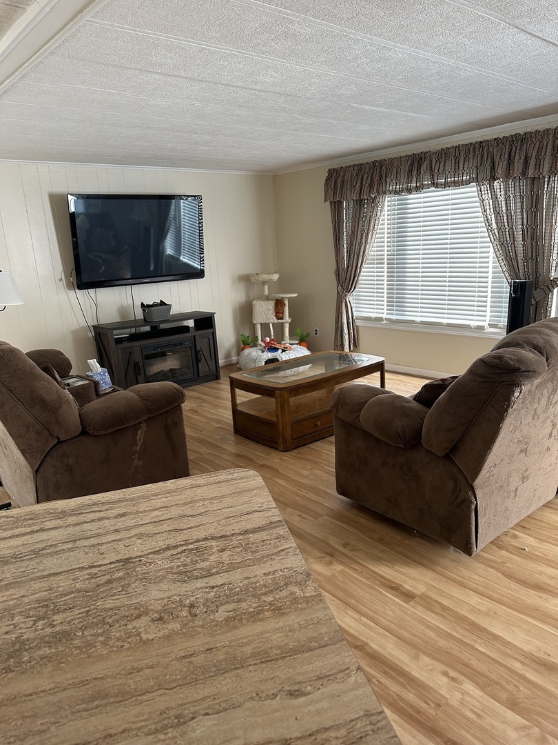 6801 South La Grange Road, Unit 155 Hodgkins, IL 60525 - Photo 2 of 8 a living room with furniture and a flat screen tv