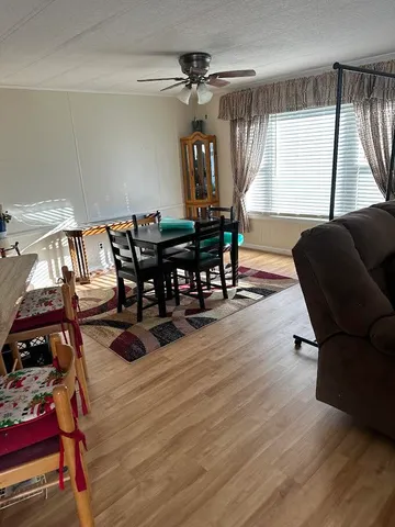 a view of a dining room with furniture and window