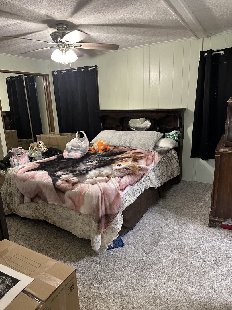 6801 South La Grange Road, Unit 155 Hodgkins, IL 60525 - Photo 6 of 8 a bed sitting in a bedroom next to a window