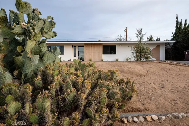 a view of a house with a yard and a garden