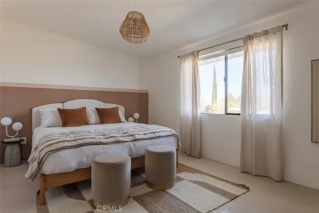 a bedroom with a bed and cabinet