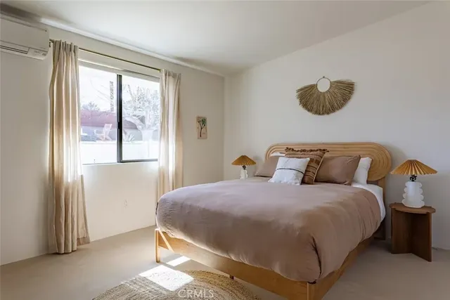 a room with painting on the wall and a window