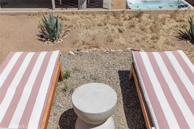 a view of a backyard with chairs and a wooden floor