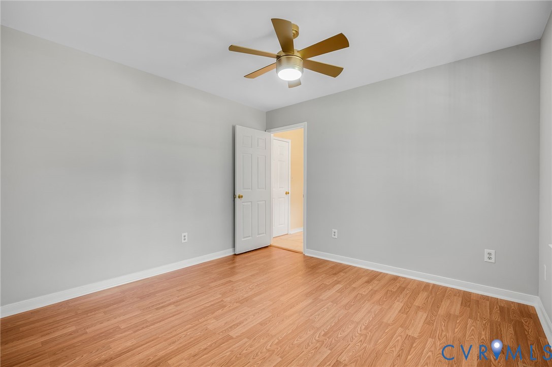 10110 Holly Road Mechanicsville, VA 23116 - Photo 18 of 26 Room featuring wood-finish flooring, light grey wa