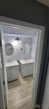 a bathroom with a sink and mirror