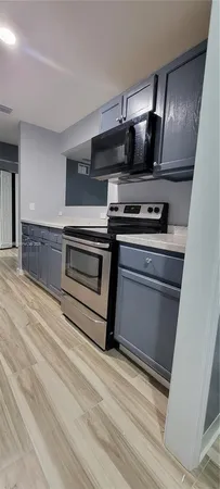 a kitchen with appliances and cabinets