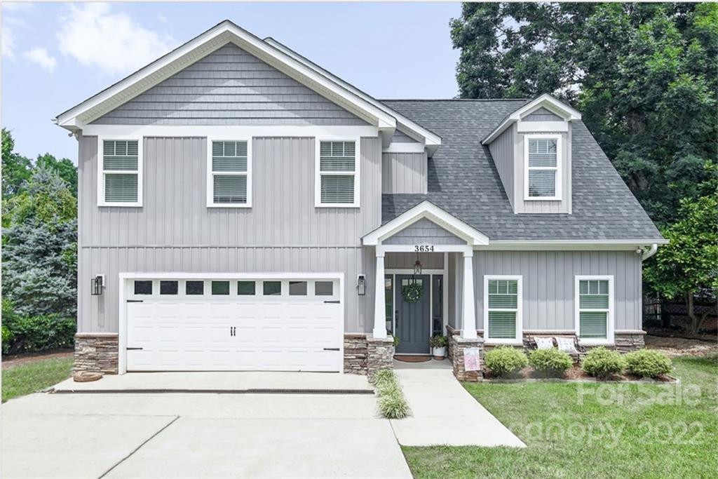 3654 Lake Shore Road South Denver, NC 28037 - Photo 1 of 48 a front view of a house with a yard and garage