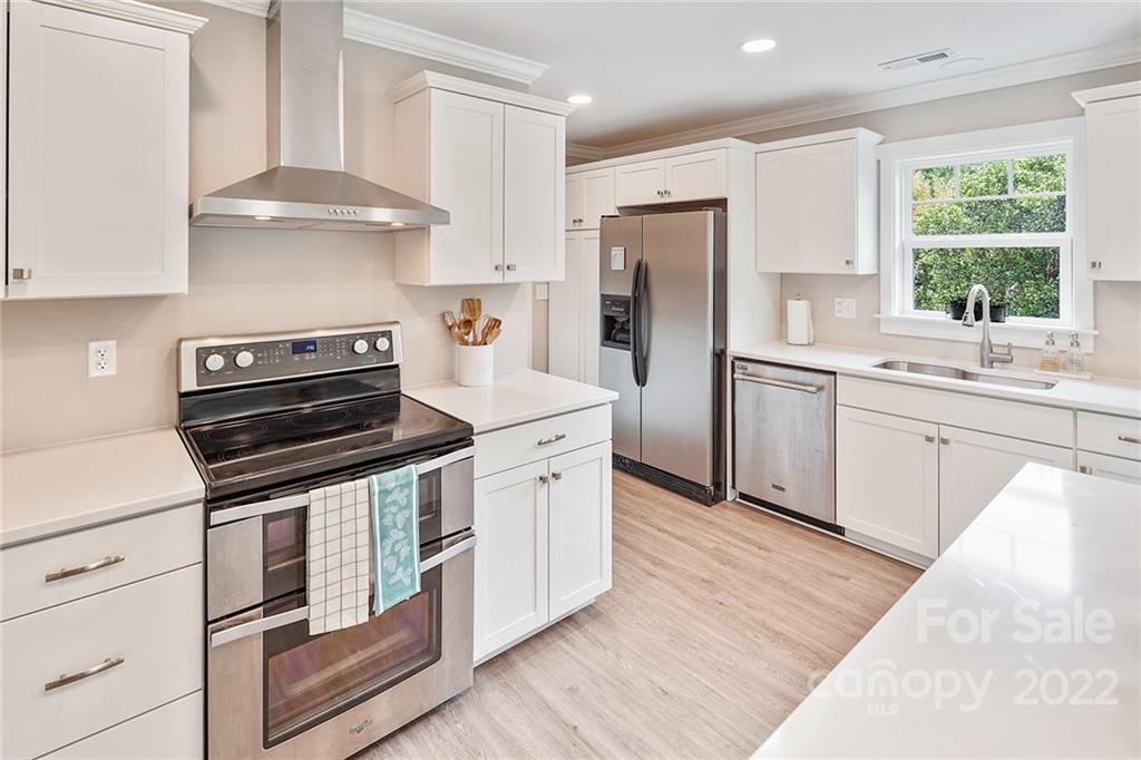 3654 Lake Shore Road South Denver, NC 28037 - Photo 12 of 48 a kitchen with stainless steel appliances granite countertop a stove a sink and a refrigerator