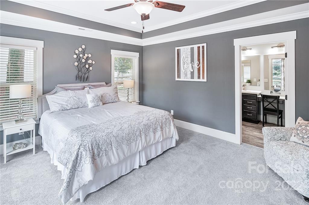 3654 Lake Shore Road South Denver, NC 28037 - Photo 17 of 48 a spacious bedroom with a bed and a chandelier