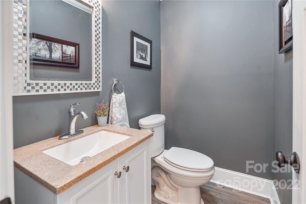3654 Lake Shore Road South Denver, NC 28037 - Photo 23 of 48 a bathroom with a toilet a sink and a mirror