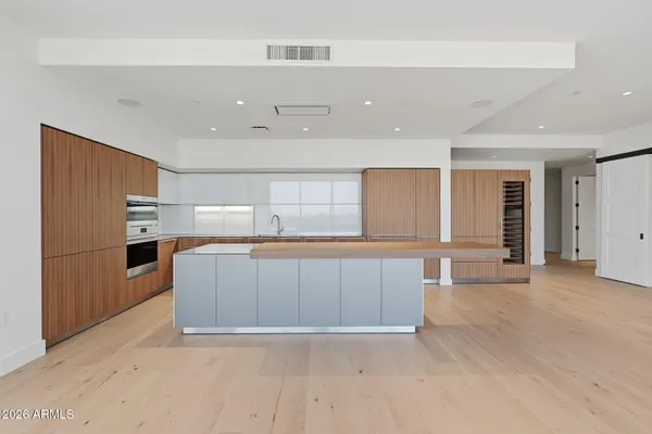 a open kitchen with stainless steel appliances granite countertop a stove and a refrigerator