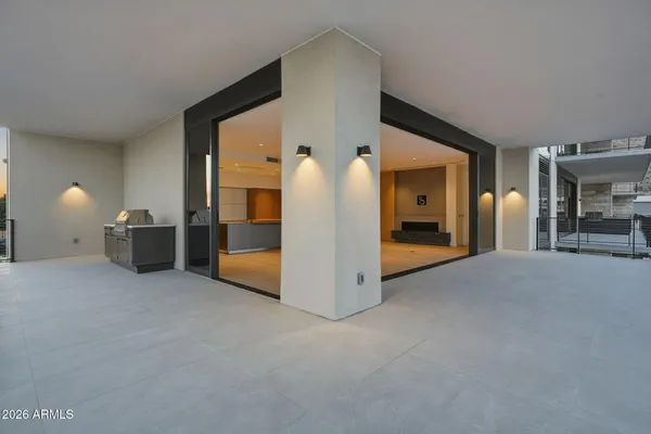a living room with lots of furniture and view of kitchen