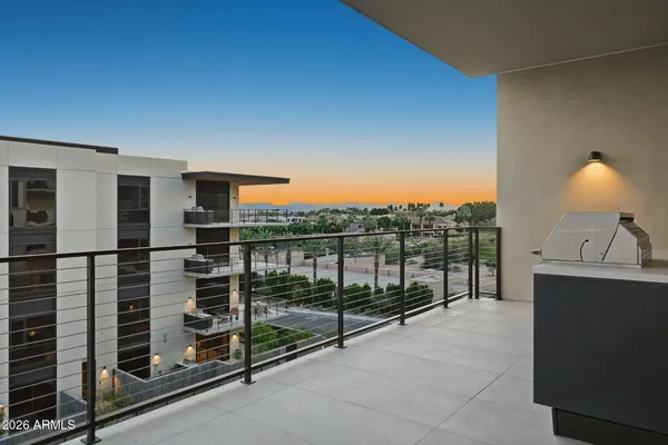 a living room with furniture and floor to ceiling windows