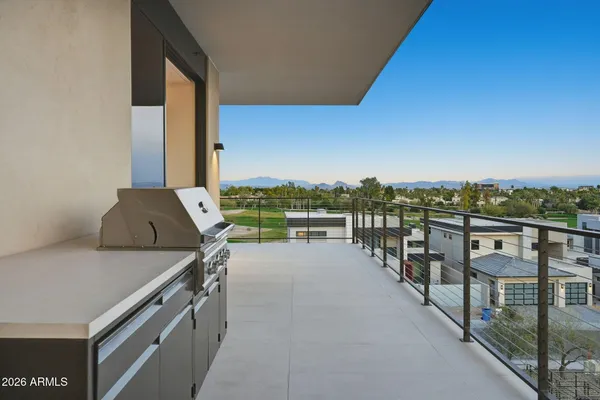 a living room with furniture a rug and a floor to ceiling window