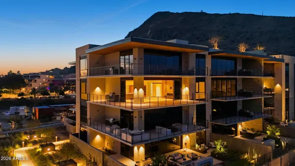 a view of a patio with couches table and chairs and potted plants
