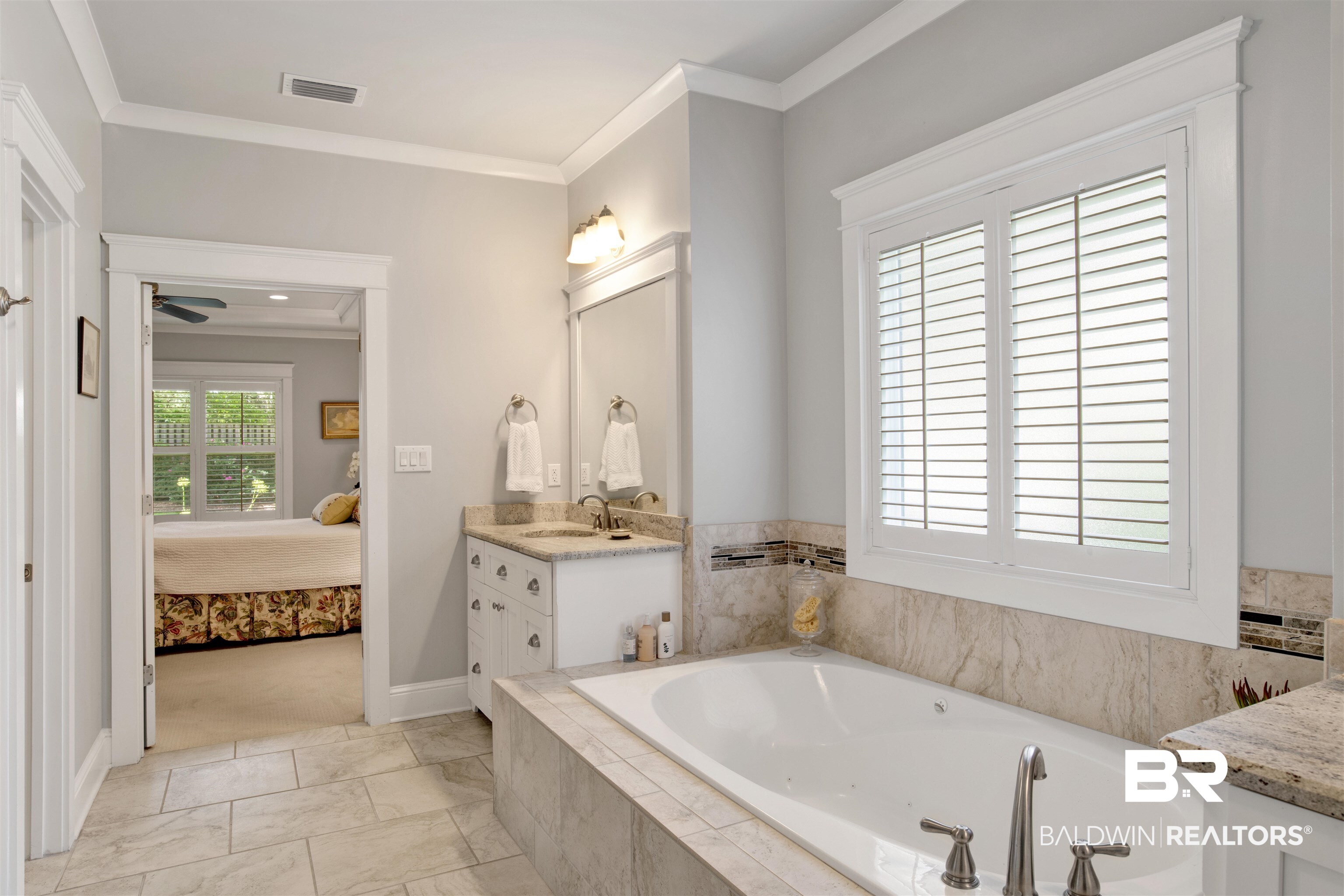 131 Sedgefield Avenue Fairhope, AL 36532 - Photo 26 of 50 Bathroom featuring vanity, crown molding, tile patterned floors, and tiled tub