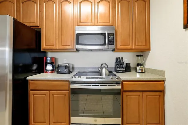 a kitchen with stainless steel appliances granite countertop a sink stove and microwave