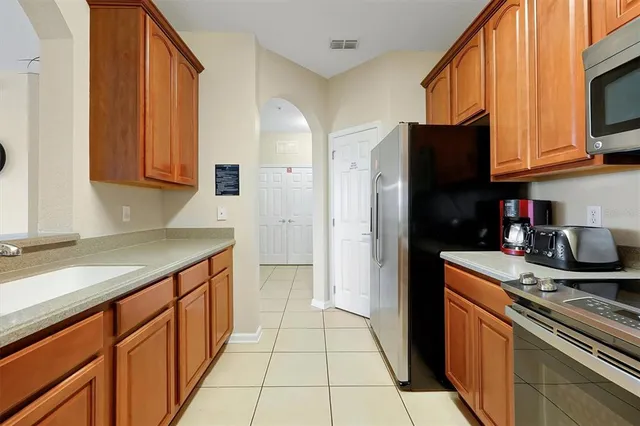 a kitchen with stainless steel appliances granite countertop a refrigerator stove and sink