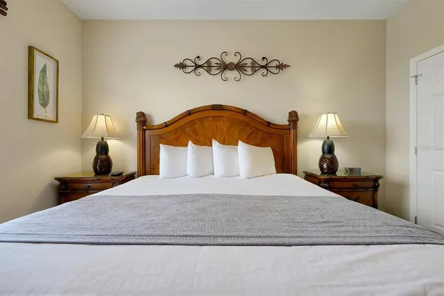 a bedroom with a bed and a night stand